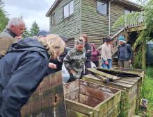 Participants inspecting the compost bins